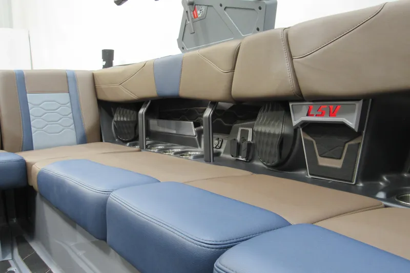 Slide: The Image of 2025 Malibu Wakesetter 23 LSV interior seating with blue and brown upholstery. - 8
