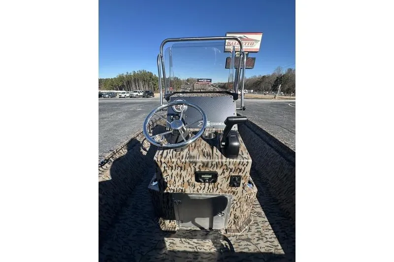 Slide: The Image of 2026 Xpress H210B Bay boat with camouflage design, featuring steering console and controls. - 1