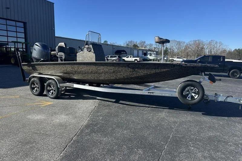 Slide: The Image of 2026 Xpress H210B Bay boat on trailer in parking lot, clear sky background. - 3