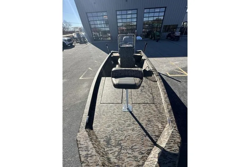 Slide: The Image of 2026 Xpress H210B Bay boat with camouflage design, parked outdoors. - 4