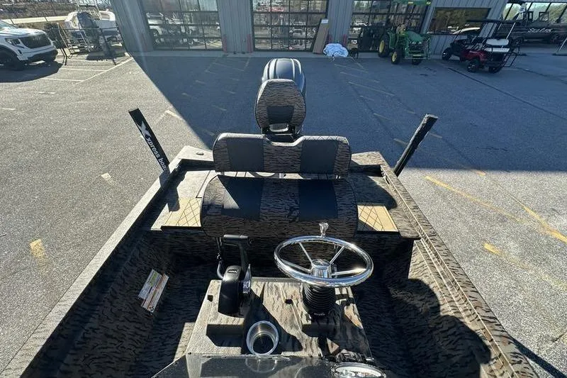 Slide: The Image of 2026 Xpress H210B Bay boat interior with steering wheel and seating, parked outdoors. - 6