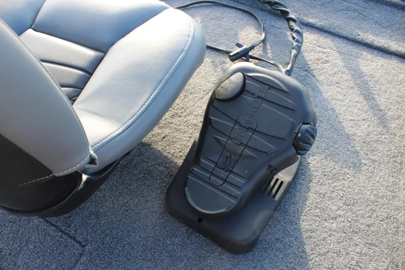 Slide: The Image of 2024 Tracker Pro 170 boat interior with foot pedal and seat detail. - 13