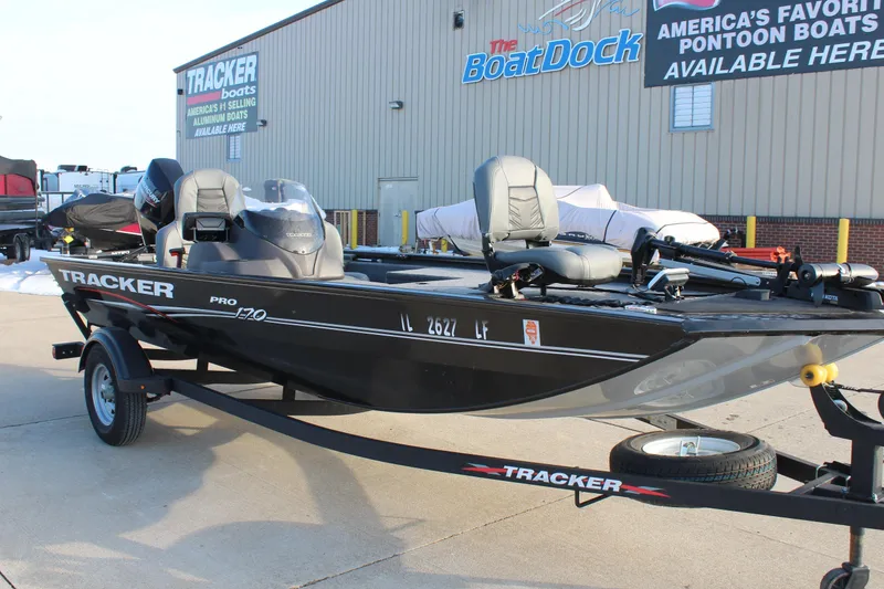 Slide: The Image of 2024 Tracker Pro 170 boat on trailer at dealership, showcasing sleek design and features. - 3