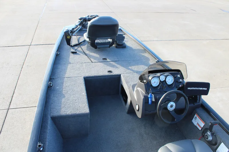 Slide: The Image of 2024 Tracker Pro 170 boat interior with steering console and fishing equipment. - 9