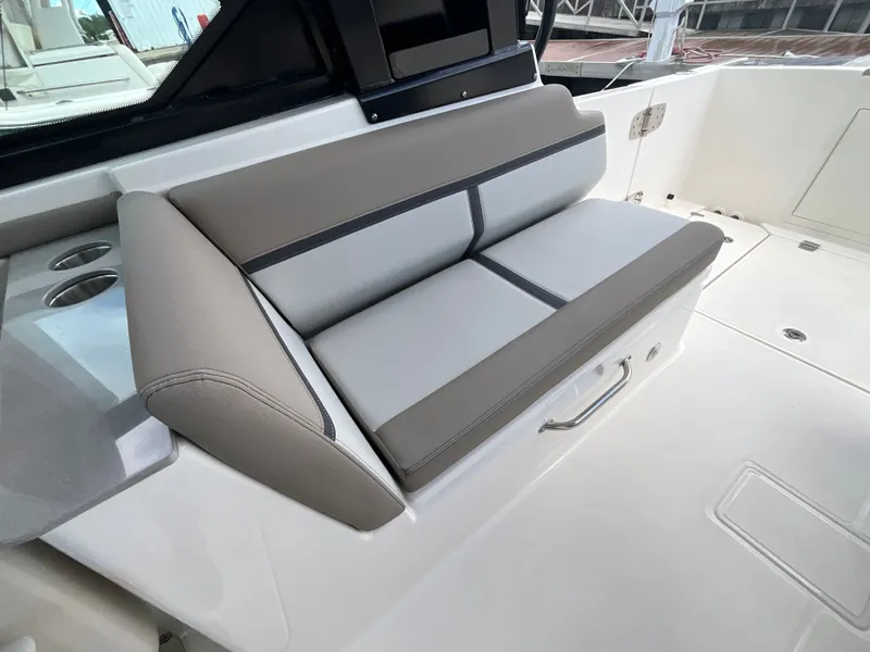 Slide: The Image of The 2026 Boston Whaler 330 Vantage features a sleek bench seat with gray upholstery. - 18