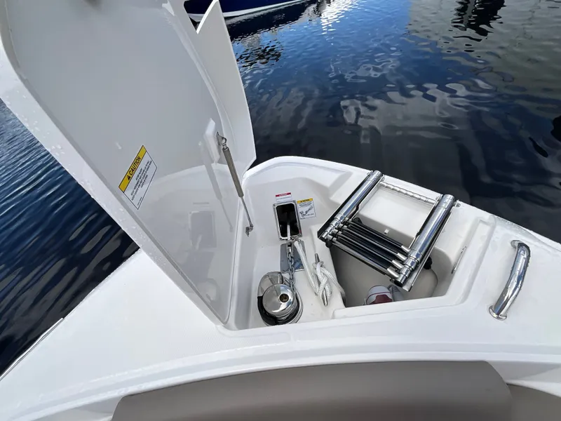 Slide: The Image of An open storage compartment on a boat with a ladder and other items, surrounded by water. - 28