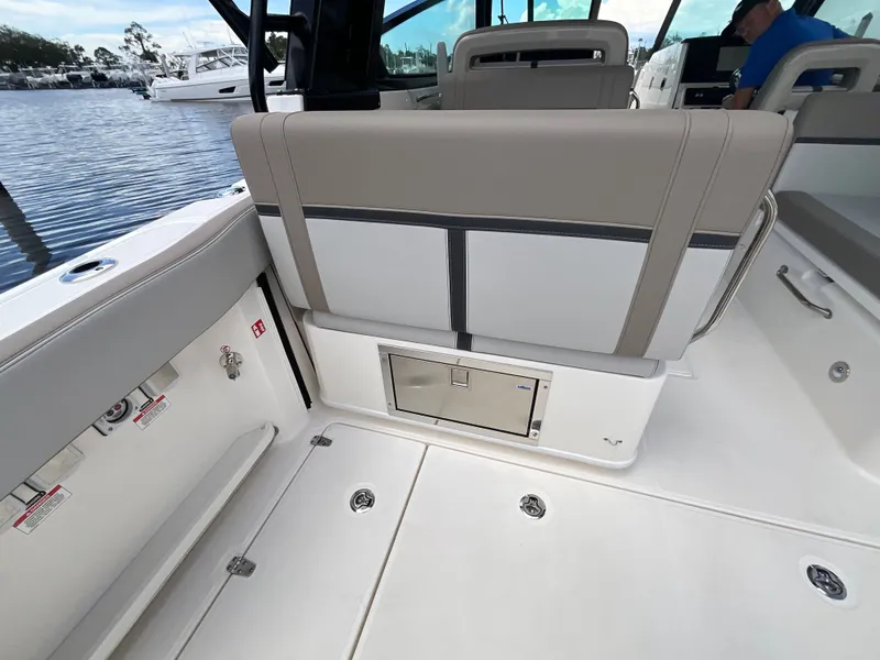 Slide: The Image of The image shows the cockpit of a Boston Whaler 330 Vantage with beige and white seating. - 14