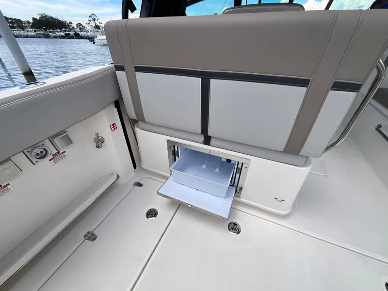 Slide: The Image of The image shows the interior of a Boston Whaler 330 Vantage with an open storage compartment. - 17