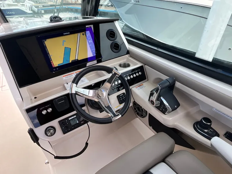Slide: The Image of The Boston Whaler 330 Vantage cockpit features a modern helm with a large navigation screen. - 23