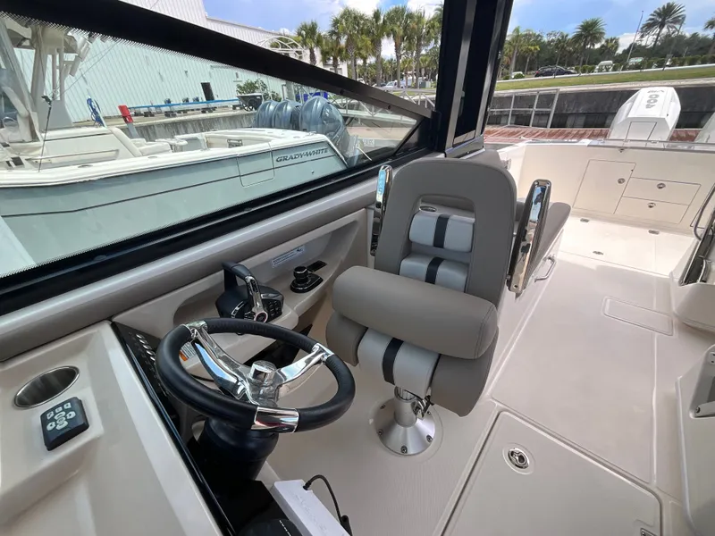 Slide: The Image of The image shows the cockpit of a Boston Whaler 330 Vantage with a modern helm and comfortable seating. - 24