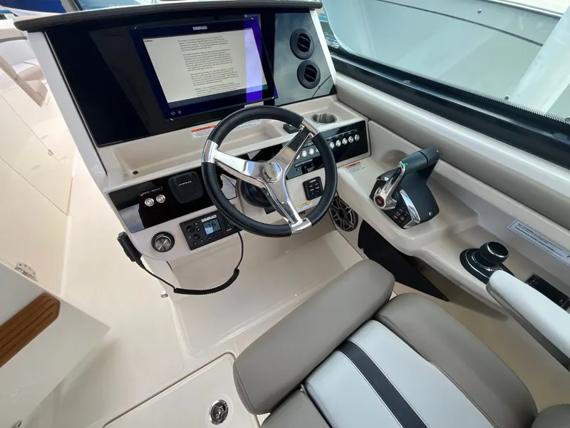 Slide: The Image of Helm of the Boston Whaler 330 Vantage with modern display and controls. - 25