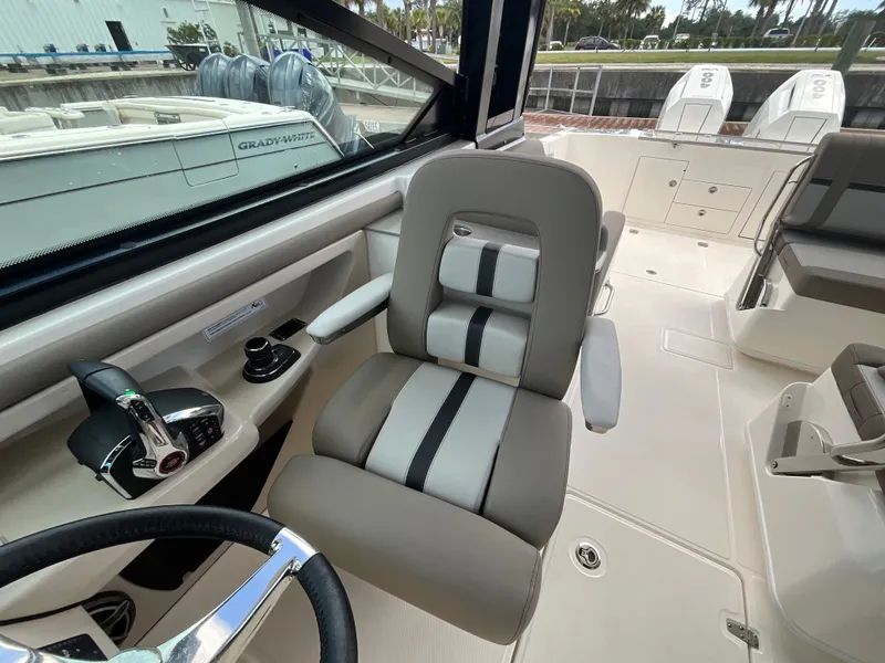 Slide: The Image of The image shows the helm of a Boston Whaler 330 Vantage with a comfortable captain's chair. - 26