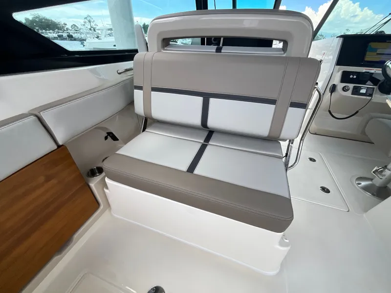 Slide: The Image of Interior view of a Boston Whaler 330 Vantage with cushioned seating and helm console. - 16