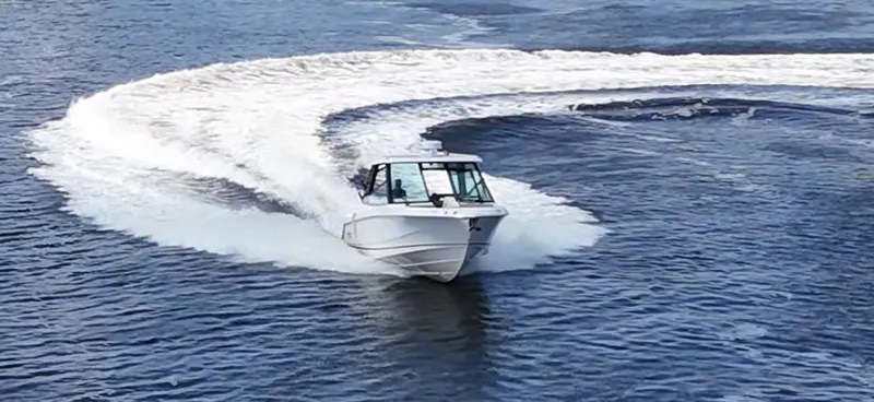 Slide: The Image of A 2026 Boston Whaler 330 Vantage speeds across the water, leaving a large wake behind. - 5