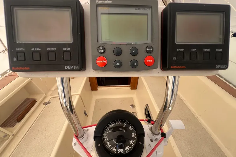 Slide: The Image of Caliber 35 LRC 1996 yacht dashboard with depth, speed, and autopilot instruments. - 10