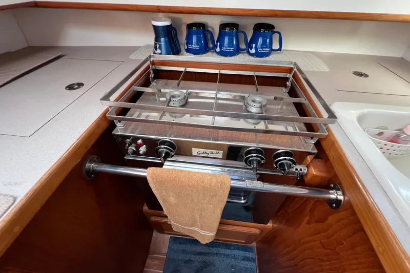Slide: The Image of 1996 Caliber 35 LRC yacht kitchen with stove, mugs, and towel. - 21