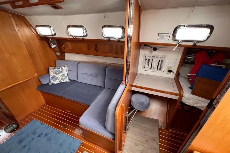 Slide: The Image of Interior of 1996 Caliber 35 LRC sailboat with cozy seating and wooden finishes. - 24