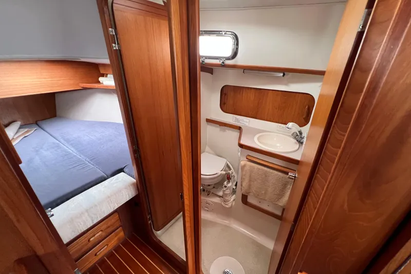 Slide: The Image of 1996 Caliber 35 LRC yacht interior with cozy cabin and compact bathroom. - 31