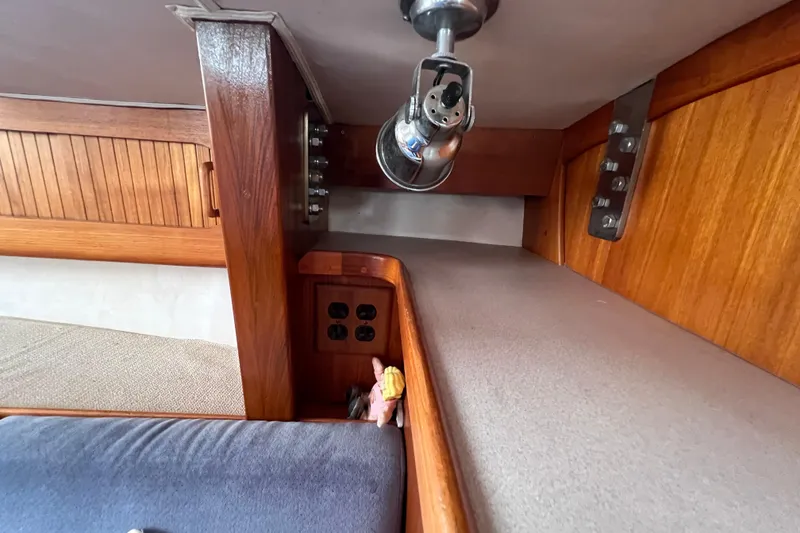 Slide: The Image of Interior of 1996 Caliber 35 LRC sailboat with wooden cabinetry and lighting fixture. - 33