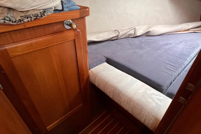 Slide: The Image of Cozy cabin interior of 1996 Caliber 35 LRC sailboat with wooden cabinetry and bed. - 34