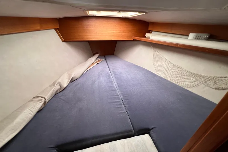 Slide: The Image of Cozy cabin interior of 1996 Caliber 35 LRC sailboat with blue bedding. - 35