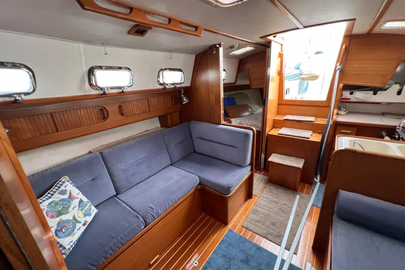 Slide: The Image of Interior of 1996 Caliber 35 LRC sailboat with cozy seating and wooden finishes. - 37