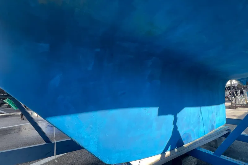 Slide: The Image of Blue hull of a 1996 Caliber 35 LRC sailboat on a trailer. - 4