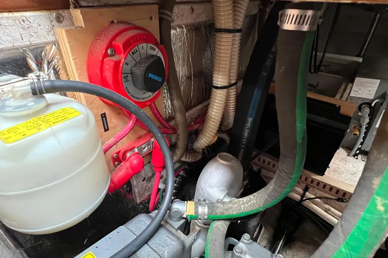 Slide: The Image of Engine compartment of a 1996 Caliber 35 LRC sailboat with hoses and wiring. - 43