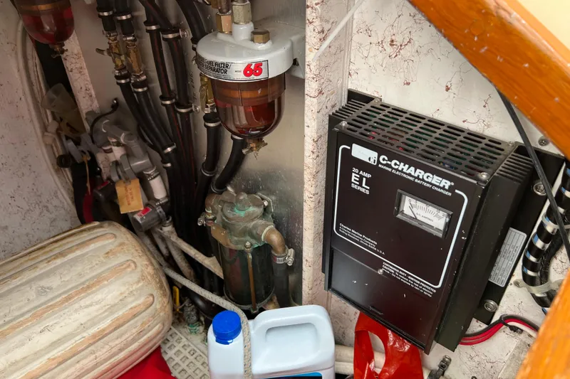 Slide: The Image of Engine room of 1996 Caliber 35 LRC with fuel filter and battery charger. - 44