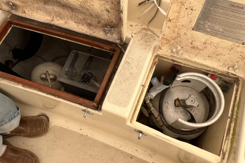 Slide: The Image of Open compartments on a 1996 Caliber 35 LRC boat showing storage and equipment. - 48