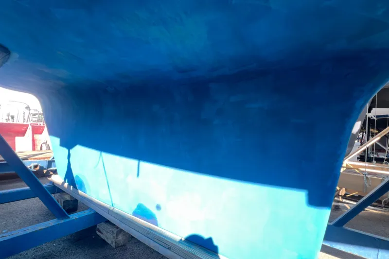 Slide: The Image of Blue hull of a 1996 Caliber 35 LRC sailboat on a stand. - 53