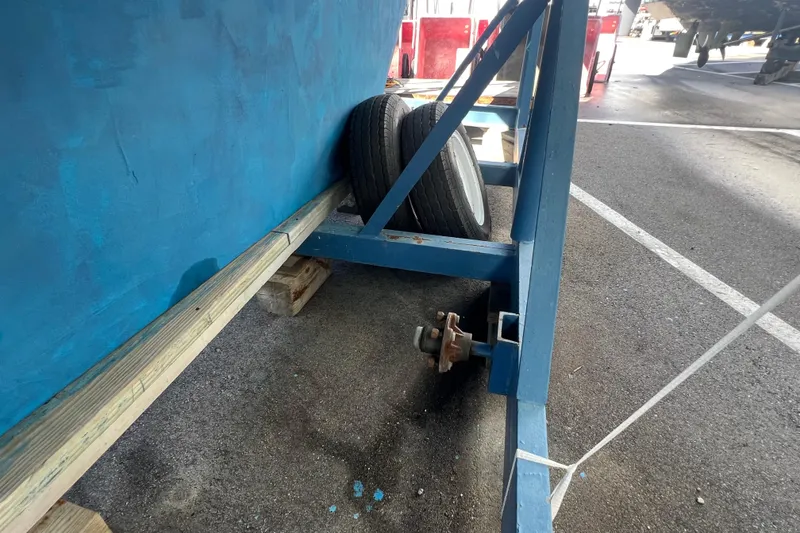 Slide: The Image of Blue boat hull on trailer with spare tires, Caliber 35 LRC, 1996 model. - 57