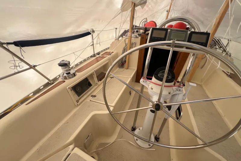 Slide: The Image of 1996 Caliber 35 LRC sailboat cockpit with steering wheel and navigation instruments. - 7