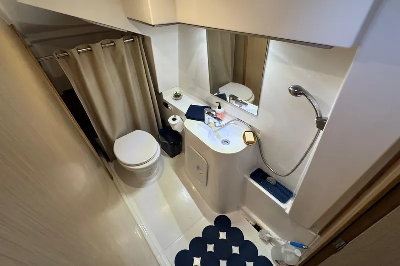 Slide: The Image of Compact bathroom in 2023 NEEL 43 model, featuring shower, sink, and toilet. - 11