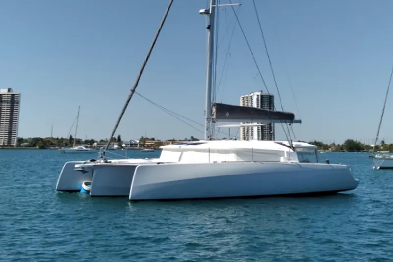 Slide: The Image of 2023 NEEL 43 trimaran sailing on calm waters near city skyline. - 15