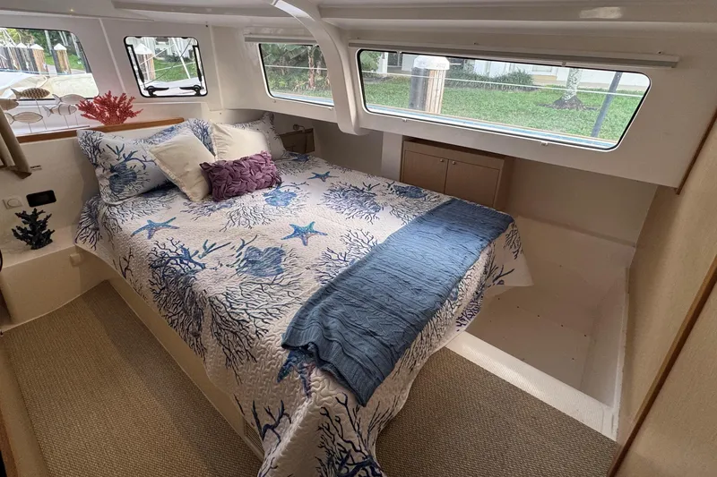 Slide: The Image of Cozy bedroom in 2023 NEEL 43 yacht with nautical-themed bedding and large windows. - 9