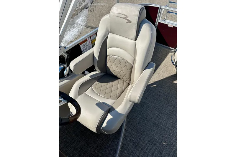 Slide: The Image of Luxurious captain's chair on 2016 Bennington R21 boat, featuring quilted upholstery. - 14