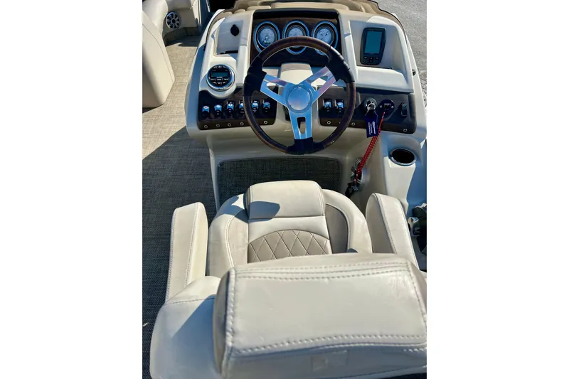 Slide: The Image of Captain's helm of 2016 Bennington R21 boat with steering wheel and controls. - 16