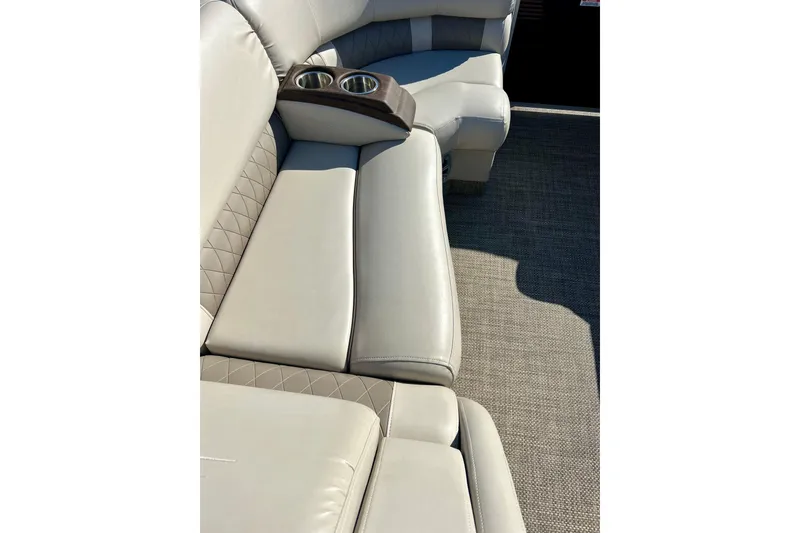 Slide: The Image of 2016 Bennington R21 boat interior with beige leather seating and cup holders. - 17