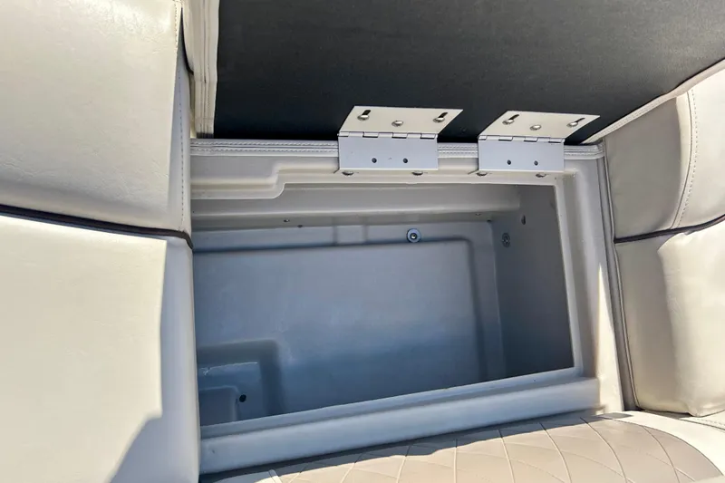 Slide: The Image of Open storage compartment in 2016 Bennington R21 boat with cushioned seating. - 34