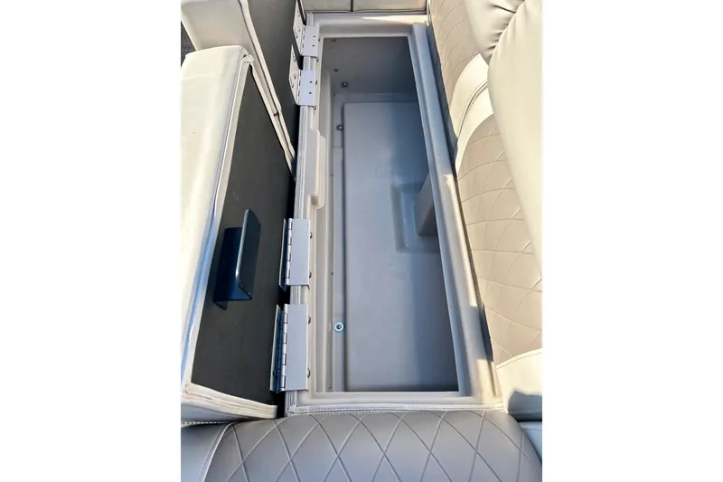Slide: The Image of 2016 Bennington R21 boat seat storage compartment, open with quilted upholstery. - 36