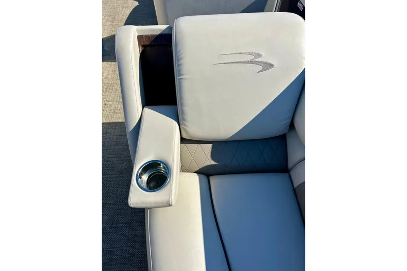 Slide: The Image of Luxurious seating on 2016 Bennington R21 boat with cup holder and logo detail. - 39