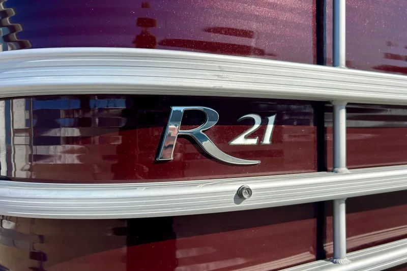 Slide: The Image of 2016 Bennington R21 boat emblem on maroon background with silver trim. - 4