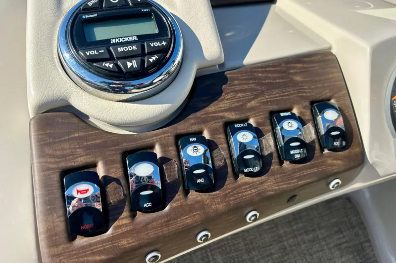 Slide: The Image of Control panel of a 2016 Bennington R21 boat with switches and audio system. - 42