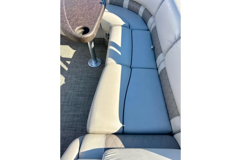 Slide: The Image of 2016 Bennington R21 boat interior with cushioned seating and table. - 48