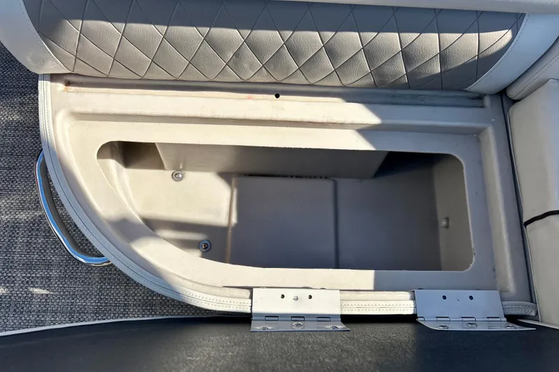 Slide: The Image of Storage compartment in 2016 Bennington R21 boat with cushioned seating. - 51