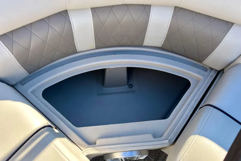 Slide: The Image of Interior storage compartment of a 2016 Bennington R21 boat with quilted upholstery. - 52