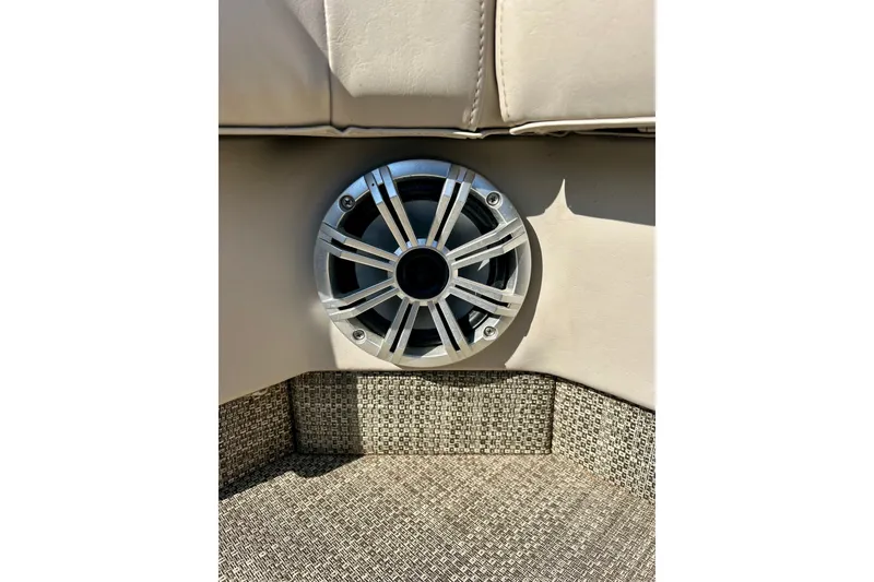 Slide: The Image of Speaker installed on 2016 Bennington R21 boat interior, featuring beige upholstery. - 54