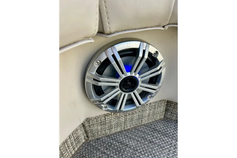 Slide: The Image of Speaker on 2016 Bennington R21 boat interior, featuring sleek design and blue lighting. - 57