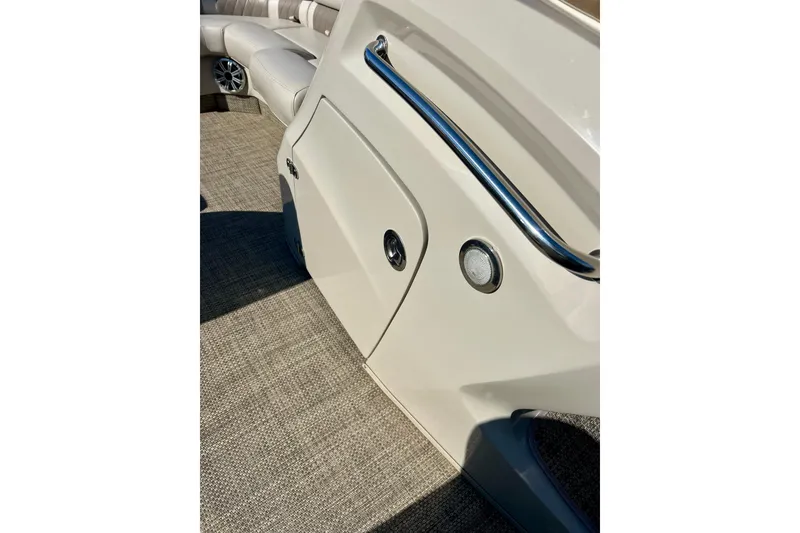 Slide: The Image of 2016 Bennington R21 boat interior with beige seating and chrome accents. - 58